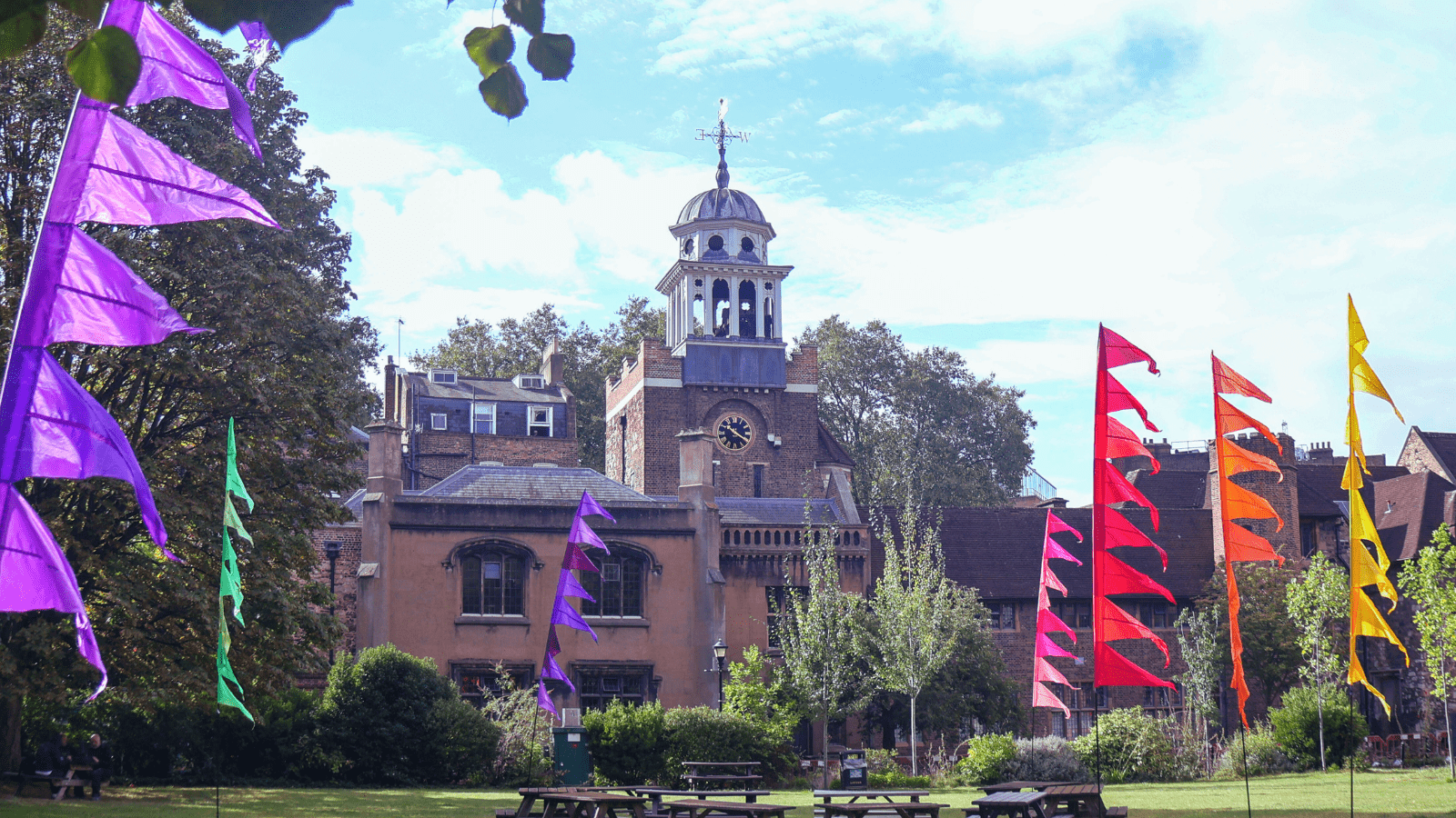 The view from the lawn at Charterhouse Square - image shows the Charterhouse surrounded by colourful banners